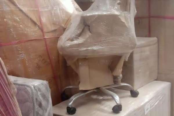 Professional movers relocating office furniture and equipment