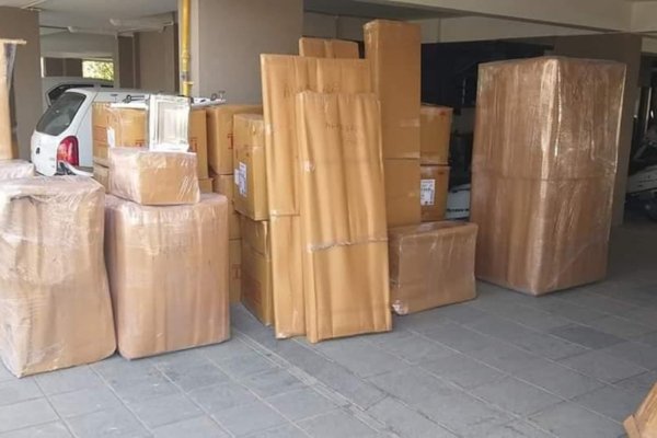 Professional packers carefully wrapping items in bubble wrap